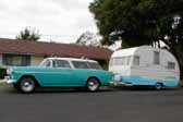 Photo shows a vintage 1955 chevy nomad wagon towing a vintage 1955 shasta trailer
