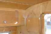 Photo shows birch wall and ceiling paneling in vintage 1955 Shasta Trailer