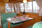 Picture shows very original dining area and upholstered bench seats in 1955 Shasta Trailer