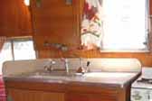 Original birch cabinets and original cabinet hardware in a 1955 Shasta Trailer