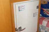 Photo of vintage white refrigerator installed in 1956 Shasta Travel Trailer