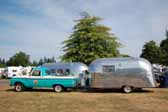 Photo shows a vintage ford f250 pickup truck tow vehicle towing a vintage 1958 airstream travel trailer