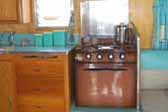 Photo shows vintage blue kitchen accessories in 1959 Shasta Airflyte Trailer