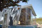 Picture of ribbed siding and curved glass on front of vintage 1960 Holiday House trailer