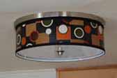 Picture of a great mid-century retro drum-styled ceiling light fixture installed in a 24ft. 1961 Holiday House vintage trailer with tandem axles