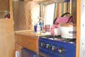 Very sharp navy blue stove and fridge in vintage 1961 Shasta Compact Trailer