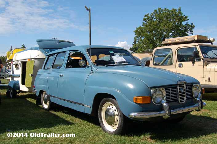 This vintage towing rig is a vintage saab 2-door station wagon pulling a 1961 trailorboat trailer