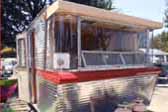 Photo of curved corner windows on front end of 1962 Holiday House Model 18 vintage trailer