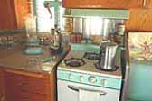 Photo shows seafoam Princess gas stove and matching hood in 1962 Shasta Trailer