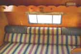 Re-finished wood storage shelf over sleeping area in 1962 Shasta Trailer 