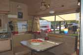 Restored and decorated dining area in a vintage Aladdin Magic Carpet travel trailer