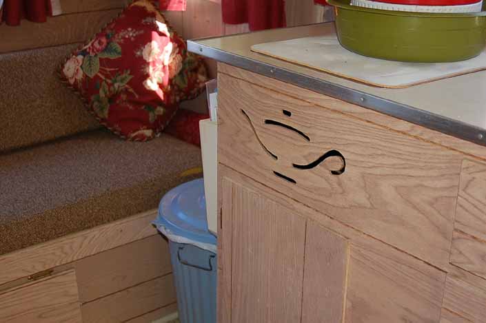 Close-up photo of the original aladdin's lamp cutout in the kitchen cabinet of an Aladdin Magic Carpet Trailer