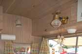 Photo shows the gas light fixture over the dining table in an Aladdin Magic Carpet model trailer