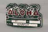 Photo of restored cast metal Aloha badge emblem on 1966 vintage Aloha travel trailer