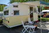 Beautifully restored 1966 Aloha travel trailer painted in buttercup yellow and white colors