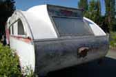 Rear-end view of an original Aero Flite vintage trailer - rough but perfect for restoration