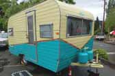 Picture of a vintage Aladdin travel trailer with a great teal and light cream yellow paint job