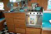 Picture of awesome kitchen cabinets, countertop and appliances in nicely restored Aloha trailer