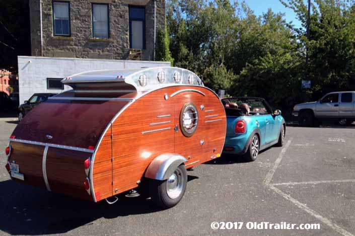 This vintage towing rig is a mini cooper convertible pulling a custom-made teardrop trailer