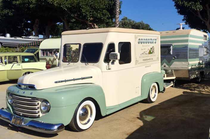 This vintage towing rig is a 1950 ford milk truck pulling a vintage winnebago travel trailer