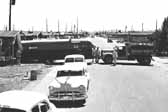 Historical photo shows a newly arrived travel trailer being backed into place, at Project Hanford Trailer City in Washington