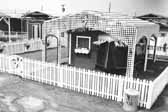 Government photo shows a worker's 1940's vintage protected by a lattice shade cover at the Project Hanford Trailer City