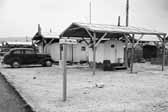 Government photo shows a collection of small vintage trailers from the 1940's, at the Project Hanford Trailer City in Washington