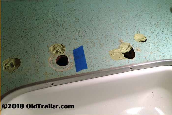 This photo shows how you use use epoxy filler to patch the holes in the vintage formica laminate