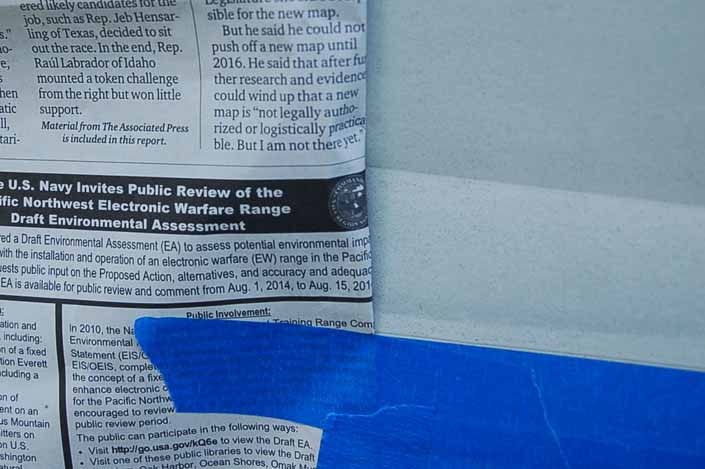 Picture of a repaired dent in a vintage trailer being masked off in preparation for painting