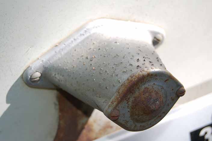 Photo shows an original bargman license plate lamp on a vintage trailer that really needs to be restored 