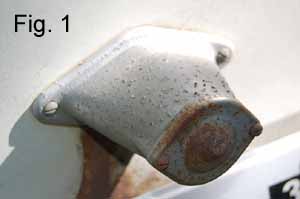 Image shows the original rusty and dented vintage trailer license plate lamp before restoration