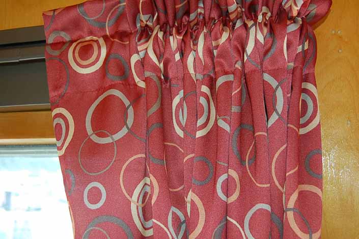 This photo shows a swatch of retro fabric with a colorful circles design, for your vintage trailer