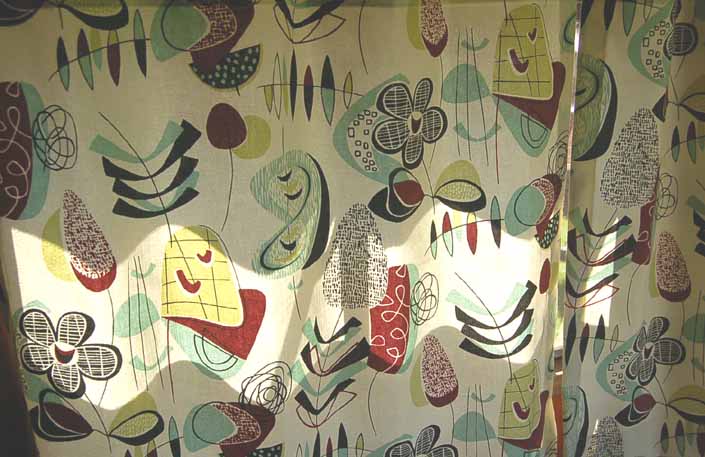 This photo shows a swatch of retro fabric with a jazzy mid-century boomerangs and dingbats pattern, for your vintage trailer