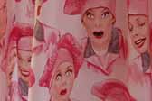 This photo shows a swatch of retro fabric with i love lucy in a chef's hat, for your vintage trailer