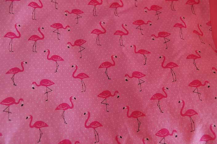 This photo shows a swatch of retro fabric with pink flamingos for your vintage trailer