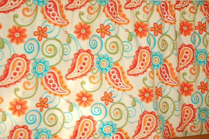 This photo shows a swatch of retro fabric with a 1960's psychedelic paisley design, for your vintage trailer