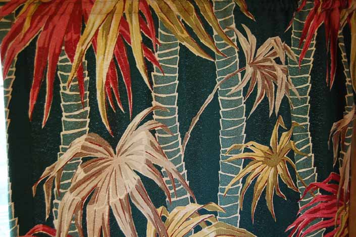 This photo shows a swatch of retro fabric with a vintage bamboo and tropical flowers pattern, for your vintage trailer
