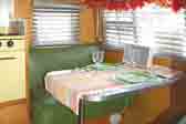 Photo of green dinette seat cushion upholstery in vintage Shasta trailer
