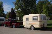 Picture of a ford pickup truck vintage tow vehicle towing a vintage trillium travel trailer