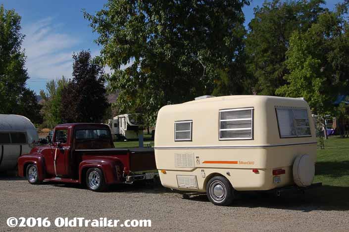 This vintage towing rig is a classic ford pickup truck pulling a fiberglass trillium travel trailer