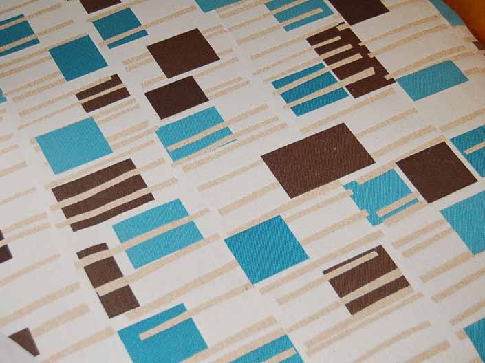 This photo shows a swatch of retro fabric with mid-century geometrics designs, for your vintage trailer