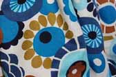 This photo shows a swatch of retro fabric with a 60's flower design for your vintage trailer