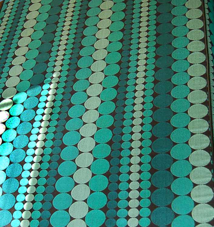 This photo shows a swatch of retro fabric with a great 1960's go-go geometric dots pattern, for your vintage trailer