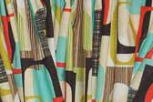 This photo shows a swatch of retro fabric with a 1960's go-go graphics pattern, for your vintage trailer