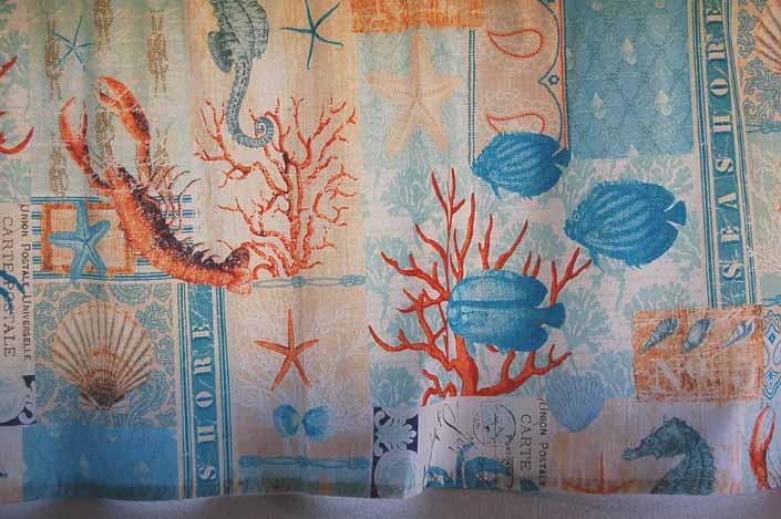 This photo shows a swatch of retro fabric with great 60's nautical feel with undersea creatures, for your vintage trailer