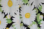 This image is a sample of a great looking retro fabric pattern showing Bright Daisies on a Black Background, for your vintage trailer