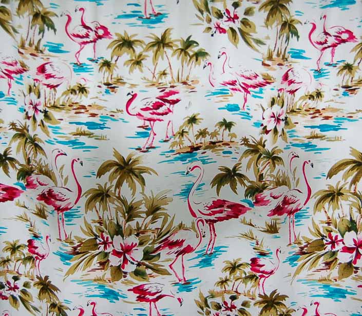This photo shows a swatch of retro fabric with a palm trees and pink flamingos pattern, for your vintage trailer