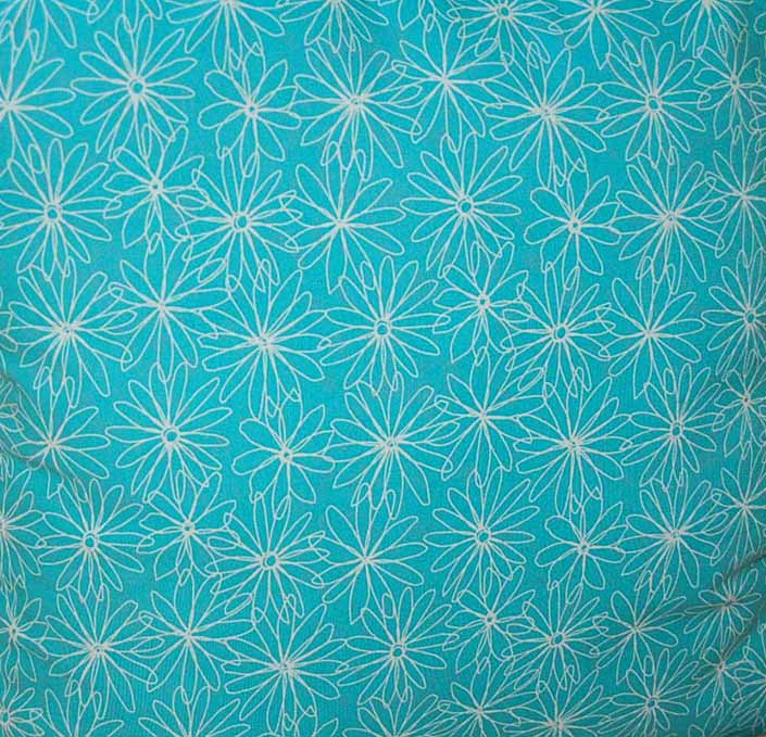 This photo shows a swatch of retro fabric with 1960's white flower graphics on a turquoise background, for your vintage trailer