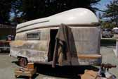 Photo of a rare fiberglass 1954 Kompak trailer with fishing boat on the roof