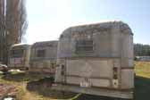 Picture shows a group of original Silver Streak trailer stored in a vintage trailer junk yard and available for restoration